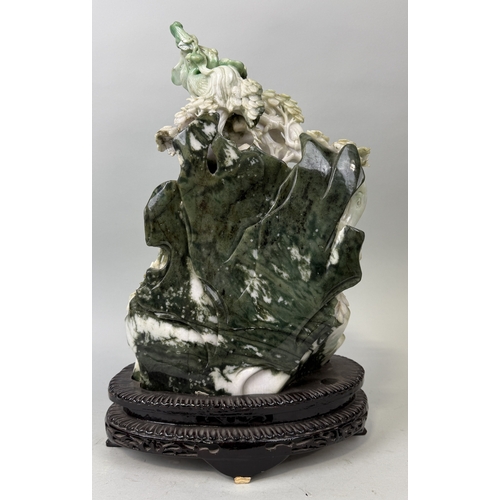 148 - A CHINESE JADE SCULPTURE DEPICTING THE SEATED GUANYIN WITH RUYI SCEPTRE, SURROUNDED BY BAMBOO SHOOTS... 