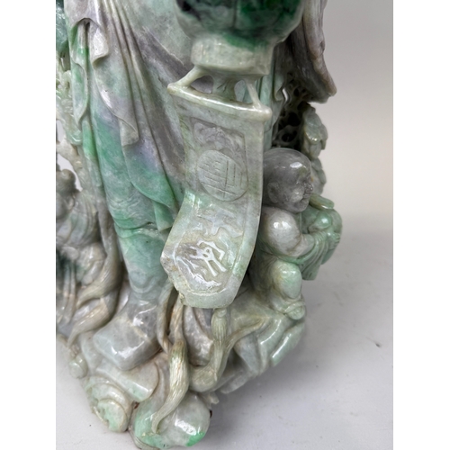 149 - A CHINESE JADE OR JADEITE CARVING POSSIBLY DEPICTING THE GOD OF WEALTH
53cm x 28cm