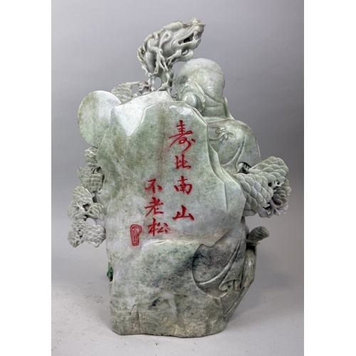 151 - A CHINESE JADE OR JADEITE SCULPTURE DEPICTING THE LUOHAN WITH A DRAGON STAFF, CHILDREN, CRANES AND F... 