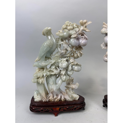 155 - A PAIR OF CHINESE JADE SCULPTURES DEPICTING BIRDS ON BRANCHES WITH FRUIT
Approximately 29cm x 21cm e... 