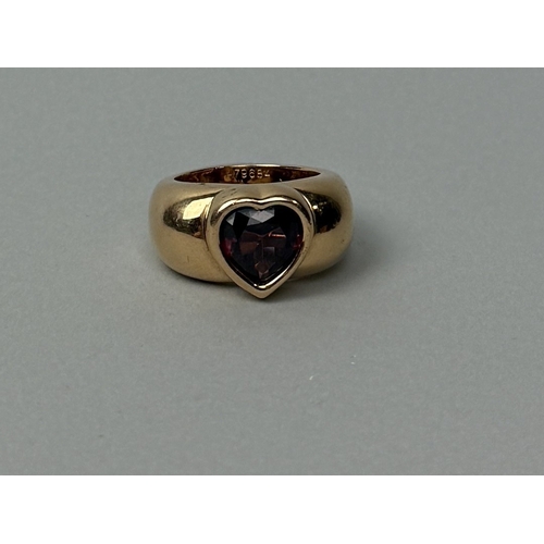 319 - A PIAGET 18CT GOLD RING SET WITH A CENTRAL RED STONE
Weight: 19.1gms