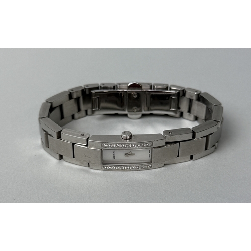 334 - A GUCCI STAINLESS STEEL WRISTWATCH, DIAMOND SET
 