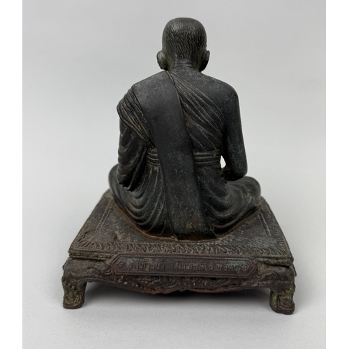 373 - A BUDDHIST BRONZE FIGURE OF A MONK
17cm x 15cm x 11cm