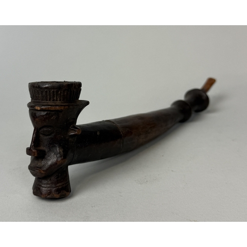 379 - AN AFRICAN WOODEN PIPE, THE BOWL CARVED WITH MAN'S FACE, 20TH CENTURY
29cm L