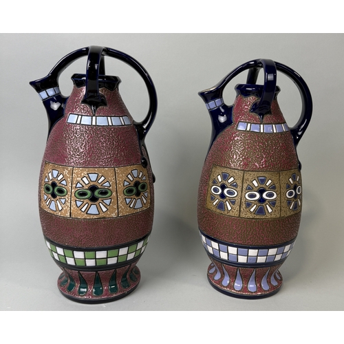 383 - A PAIR OF ART DECO CZECH AMPHORA POTTERY SPOUTED EWERS WITH CRUCIFORM HANDLES.
Height: 38cms
 ... 