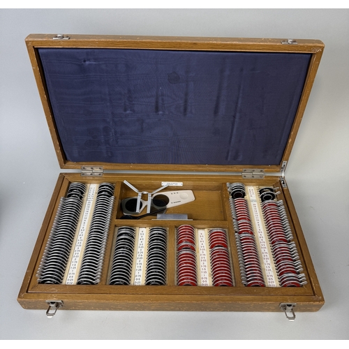 384 - AN OPTICIANS OPTOMETRIST TEST LENS SET (225 LENS) IN WOODEN CASE
54cms x 31cms x 8cms