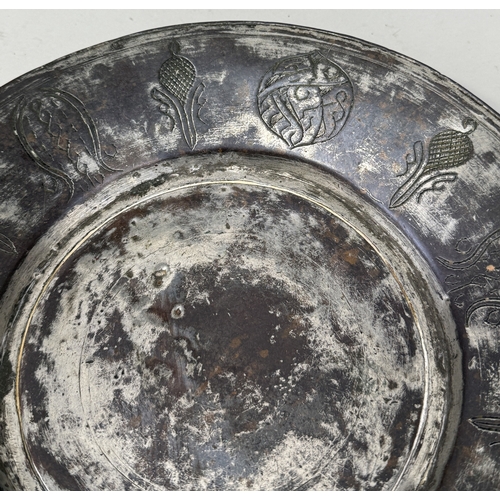 394 - AN ISLAMIC COPPER DISH WITH ENGRAVED DECORATION