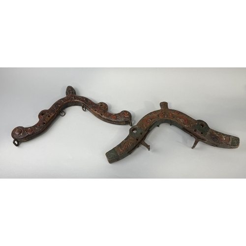 395 - TWO ANTIQUE PAINTED CARVED WOOD HARNESSES
Largest 53cm x 25cm