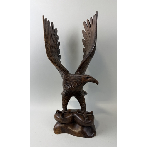 405 - A WOODEN SCULPTURE OF AN EAGLE WITH OUTSTRETCHED WINGS
51cm H