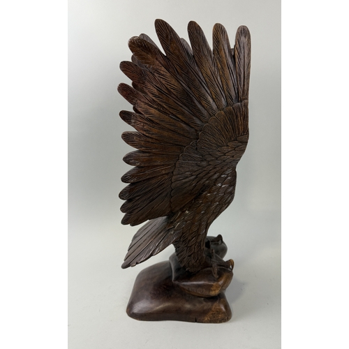 405 - A WOODEN SCULPTURE OF AN EAGLE WITH OUTSTRETCHED WINGS
51cm H