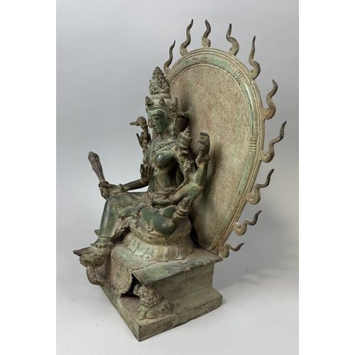 73 - A HEAVY BRONZE TARA ON DOUBLE LOTUS THRONE FRAMED BY A FLAMING AUREOLE
47cm x 36cm x 20cm... 