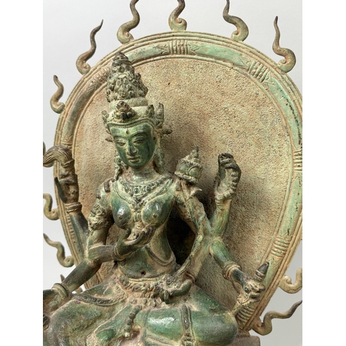 73 - A HEAVY BRONZE TARA ON DOUBLE LOTUS THRONE FRAMED BY A FLAMING AUREOLE
47cm x 36cm x 20cm... 