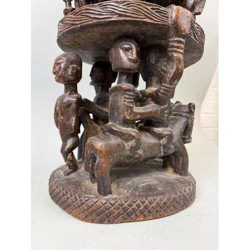 91 - A LARGE CARVED WOOD DOGON MALI CONTAINER
76cm H
Provenance: With handwritten label '1985...Bought in... 