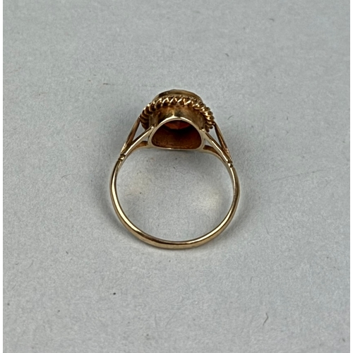 330B - A 9CT GOLD RING SET WITH AN OVAL RED STONE

Weight: 2.8gms