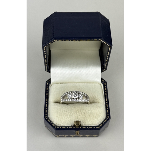 14 - AN 18CT WHITE GOLD SPLIT SHANK RING SET WITH THREE ROWS OF DIAMONDS, INCLUDING THREE LARGER CENTRAL ... 