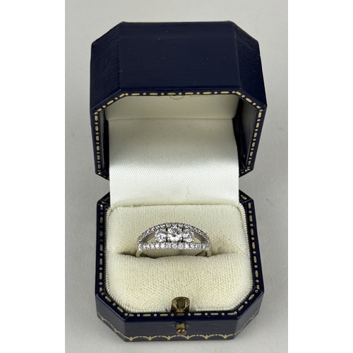 14 - AN 18CT WHITE GOLD SPLIT SHANK RING SET WITH THREE ROWS OF DIAMONDS, INCLUDING THREE LARGER CENTRAL ... 