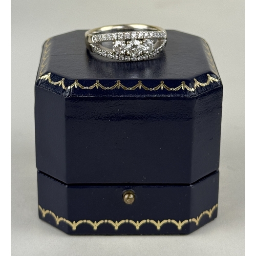 14 - AN 18CT WHITE GOLD SPLIT SHANK RING SET WITH THREE ROWS OF DIAMONDS, INCLUDING THREE LARGER CENTRAL ... 