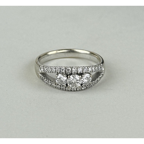 14 - AN 18CT WHITE GOLD SPLIT SHANK RING SET WITH THREE ROWS OF DIAMONDS, INCLUDING THREE LARGER CENTRAL ... 
