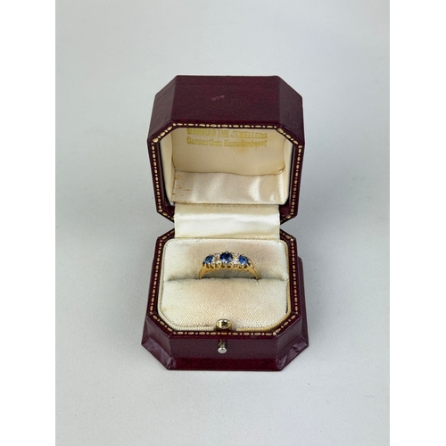 22 - AN 18CT GOLD SEVEN STONE RING SET WITH SAPPHIRES AND DIAMONDS
Weight: 4.09gms