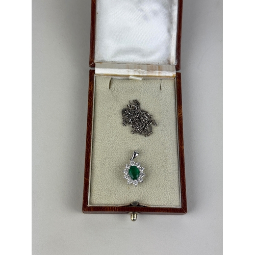 23 - AN 18CT WHITE GOLD CLUSTER DIAMOND SET PENDANT WITH CENTRAL EMERALD
Weight: 2.5gms