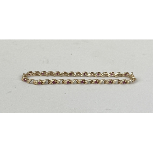 30 - A 9CT GOLD BRACELET SET WITH RUBIES AND DIAMONDS
Weight: 5.8gms