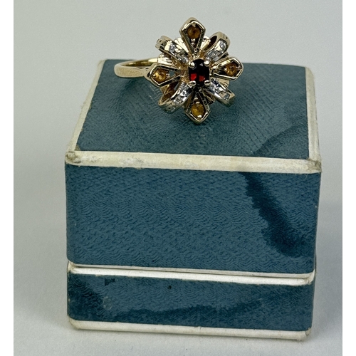 36 - A 14CT GOLD RING WITH RUBY IN CENTRE WITH DIAMONDS AND TOPAZ SURROUNDING