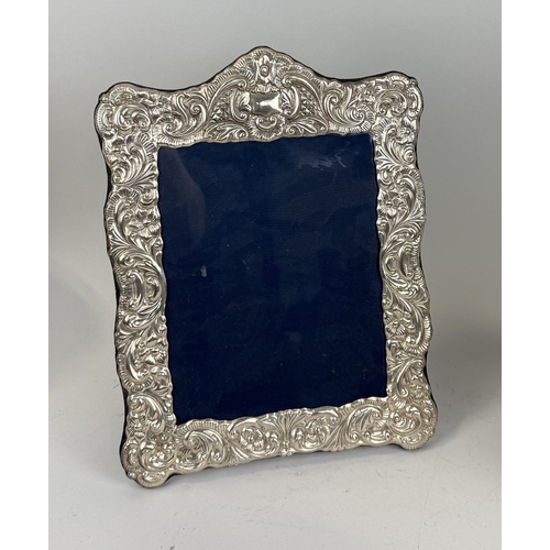 119 - A LARGE SILVER MOUNTED PHOTO FRAME
37cm x 29cm