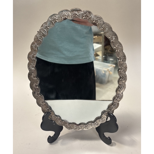 131 - A DECORATIVE TURKISH SILVER WEDDING MIRROR ON STAND
33cm x 25cm