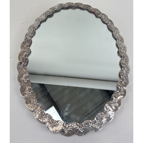 131 - A DECORATIVE TURKISH SILVER WEDDING MIRROR ON STAND
33cm x 25cm