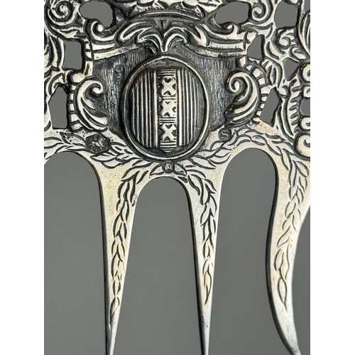 132 - AN ANTIQUE SILVER CADDY SPOON TOGETHER WITH A COMB, PROBABLY DUTCH TOGETHER WITH TWO LONG SPOONS
Tot... 