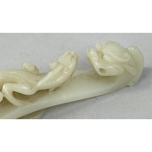 249 - A 19TH CENTURY CHINESE JADE DRAGON BELT HOOK
10cm L
