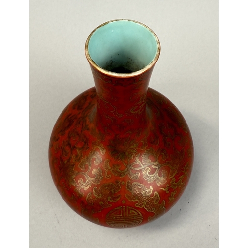 265 - A CHINESE BOTTLE VASE CORAL RED WITH GILT DETAILING
Qiang Long mark