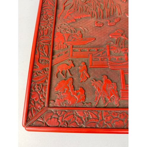 270 - A CHINESE RED LACQUERED SQUARE DISH, MING DYNASTY IN STYLE
39cm x 39cm
 