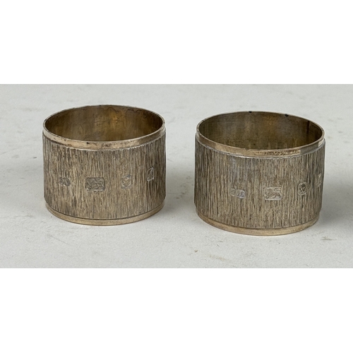 105 - A SET OF FOUR TEXTURED STERLING SILVER NAPKIN RINGS MARKED 'SJC'
Total weight: 179gms