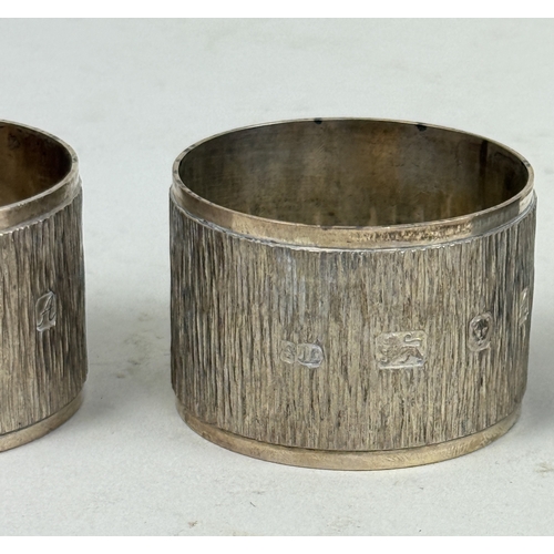 105 - A SET OF FOUR TEXTURED STERLING SILVER NAPKIN RINGS MARKED 'SJC'
Total weight: 179gms