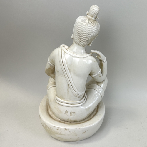 215 - A CHINESE CERAMIC BUDDHIST FIGURE ON CERAMIC BASE
33 cm H
