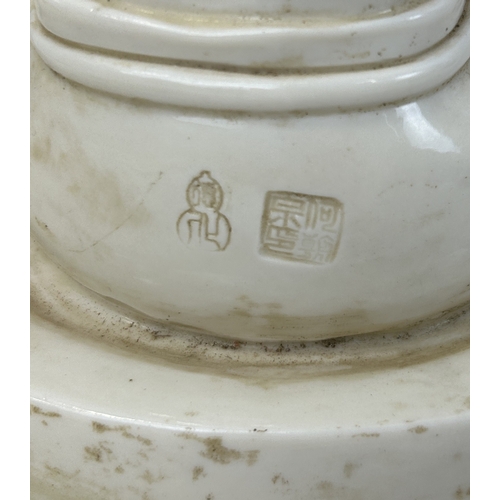 215 - A CHINESE CERAMIC BUDDHIST FIGURE ON CERAMIC BASE
33 cm H