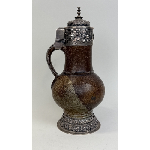 64 - A 17TH CENTURY SALT GLAZED BELLARMINE JUG WITH SILVER MOUNTS AND BASE
25cm HProvenance: Appleby Cast... 
