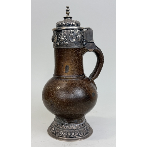 64 - A 17TH CENTURY SALT GLAZED BELLARMINE JUG WITH SILVER MOUNTS AND BASE
25cm HProvenance: Appleby Cast... 