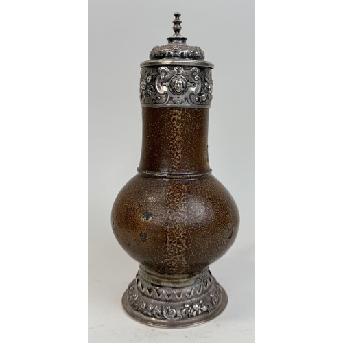 64 - A 17TH CENTURY SALT GLAZED BELLARMINE JUG WITH SILVER MOUNTS AND BASE
25cm HProvenance: Appleby Cast... 