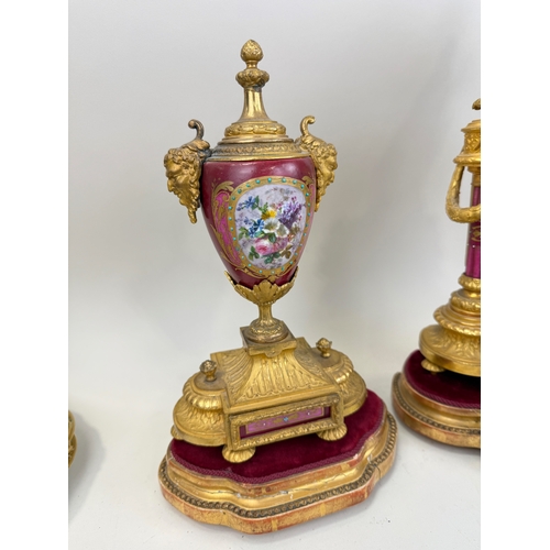 258 - AN ANTIQUE SEVRES STYLE PORCELAIN GARNITURE COMPRISING CLOCK AND TWO URNS
Tallest 43cm H
The porcela... 