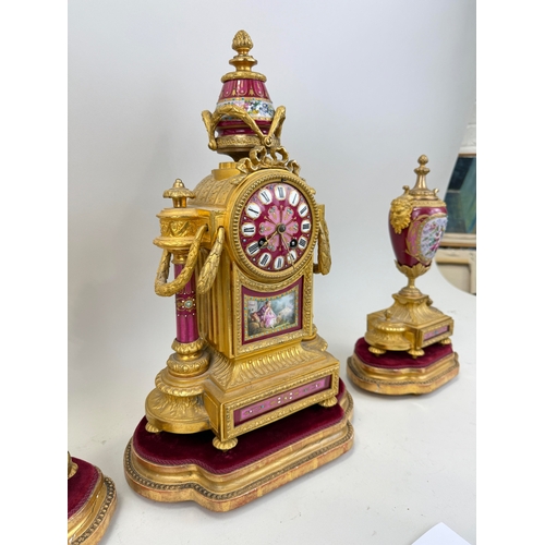 258 - AN ANTIQUE SEVRES STYLE PORCELAIN GARNITURE COMPRISING CLOCK AND TWO URNS
Tallest 43cm H
The porcela... 