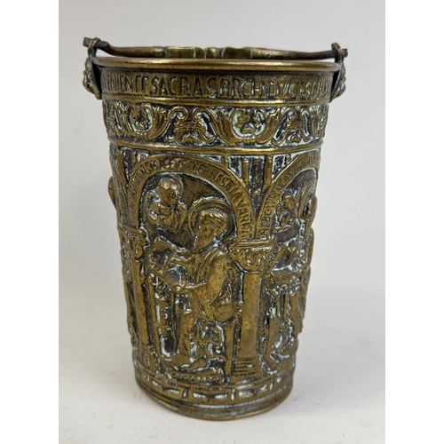 302 - AN 18TH CENTURY OR EARLIER BRASS HOLY WATER BUCKET WITH REPOUSSE RELIGIOUS SCENE
19cm H
Provenance: ... 