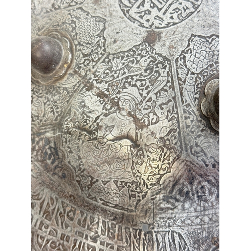 316 - AN INDO-PERSIAN SHIELD, 19TH CENTURY OR EARLIER
Possibly Islamic or Indian.
38cm W
Intricatedly deco... 
