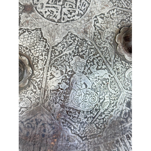 316 - AN INDO-PERSIAN SHIELD, 19TH CENTURY OR EARLIER
Possibly Islamic or Indian.
38cm W
Intricatedly deco... 