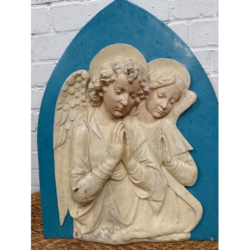 321 - IN THE MANNER OF DELLA ROBIA: A MAJOLICA PLAQUE DEPICTING ANGELS AT PRAYER
62cm x 47cm
