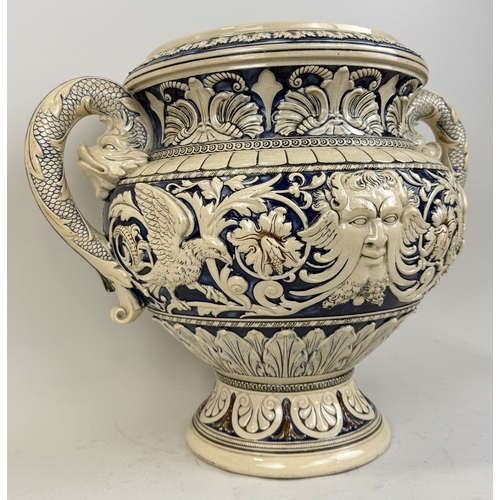328 - A MINTON-STYLE MAJOLICA TWIN HANDLED VASE WITH DOLPHIN HEAD HANDLES AND CENTRAL MASKS
51 x 41 cm... 