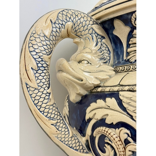 328 - A MINTON-STYLE MAJOLICA TWIN HANDLED VASE WITH DOLPHIN HEAD HANDLES AND CENTRAL MASKS
51 x 41 cm... 