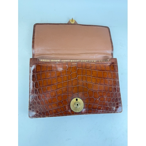 342 - ASPREY & CO LONDON: A TAN CROCODILE SKIN TRAVEL FOLIO WITH BRASS BRAMAH LONDON LOCK
35 x 26 cm... 
