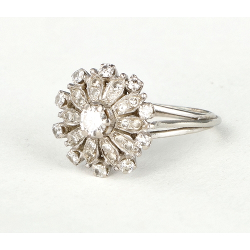 47 - AN 18 CARAT WHITE GOLD DIAMOND CLUSTER RING
The illusion set stones with the largest to the centre, ... 